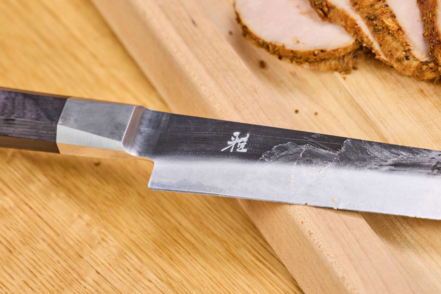 A close-up of the blade on the Miyabi Koh 9.5 Inch Slicing Knife