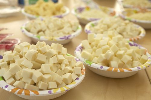 Paper bowls filled with different brands of low-moisture mozzarella cubes.