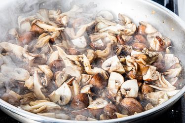 Sauting a variety of mushrooms in a pan