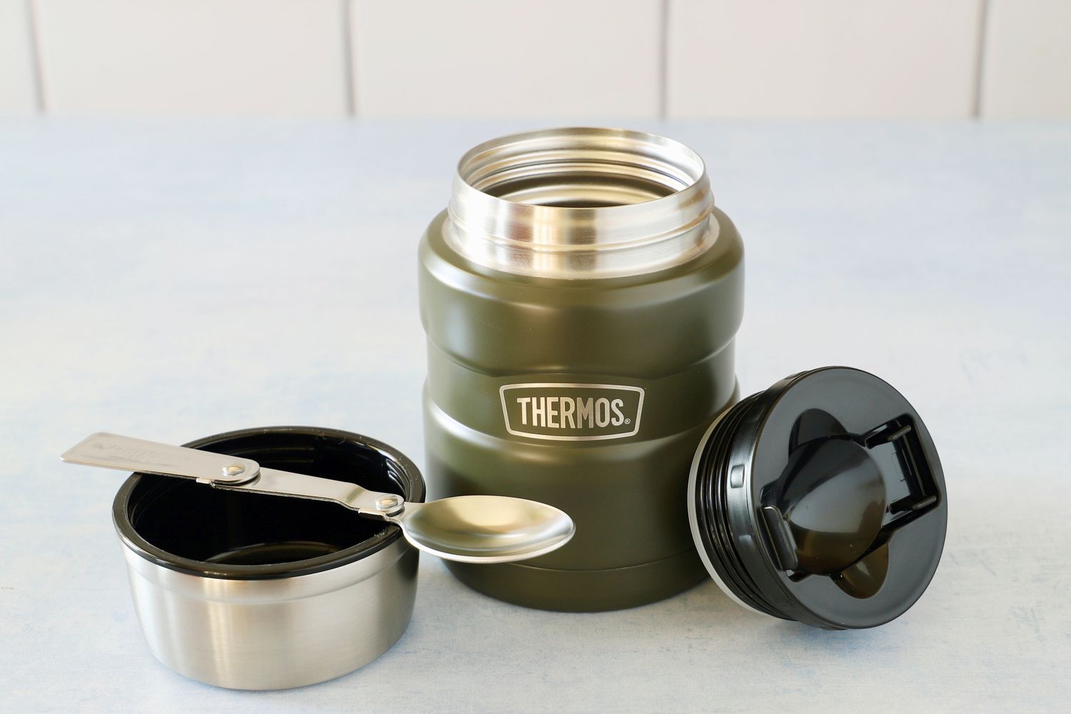 the stanley food thermos with the lid off and in the spoon resting on the cup