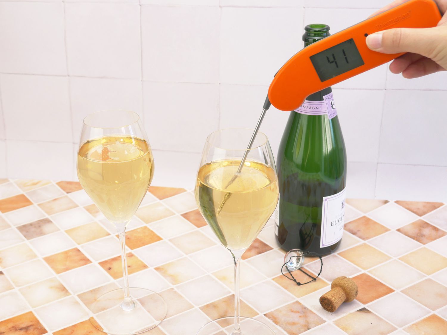 taking the temperature of chilled champagne in a glass
