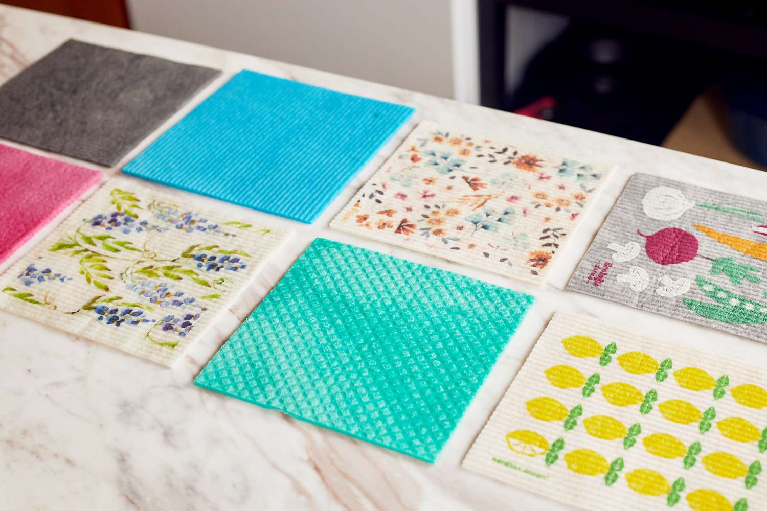 Several swedish dishcloths on a marble counter