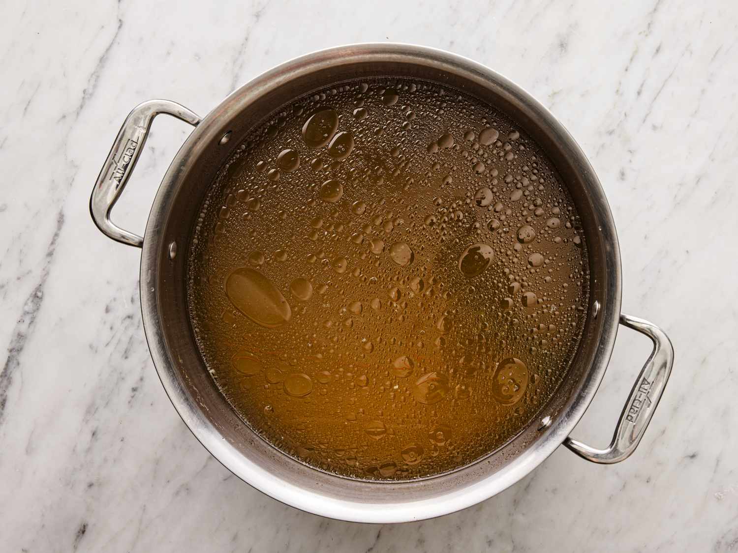 Overhead view of broth in stock pot