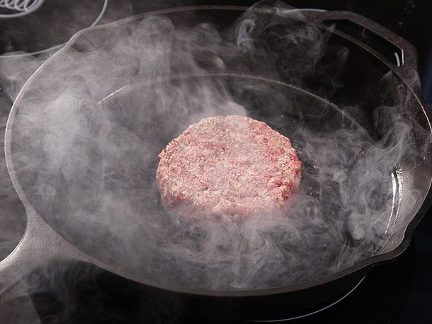 burger patty cooking on pan