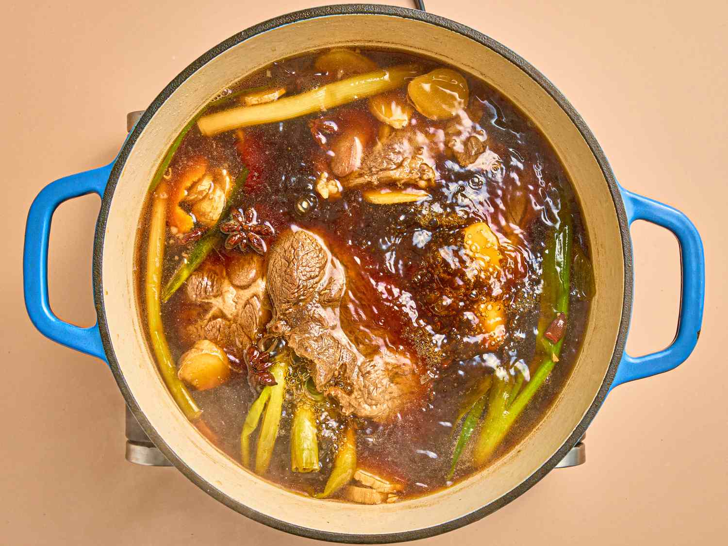 Overhead view of braising liquid in pot