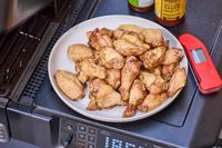 Wings cooked in the Traeger Woodridge Pro on a white plate