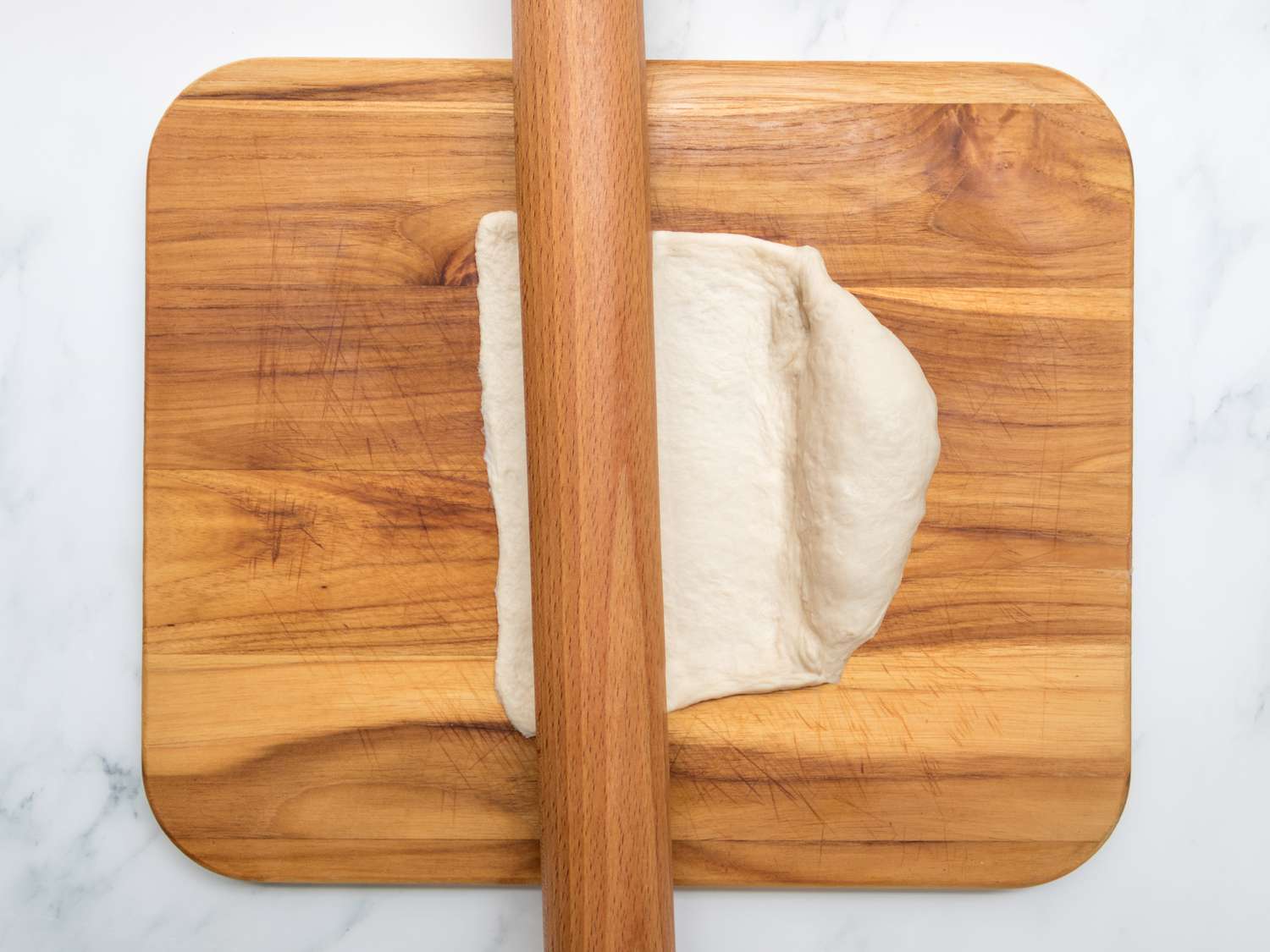 Overhead view of dough being rolled out