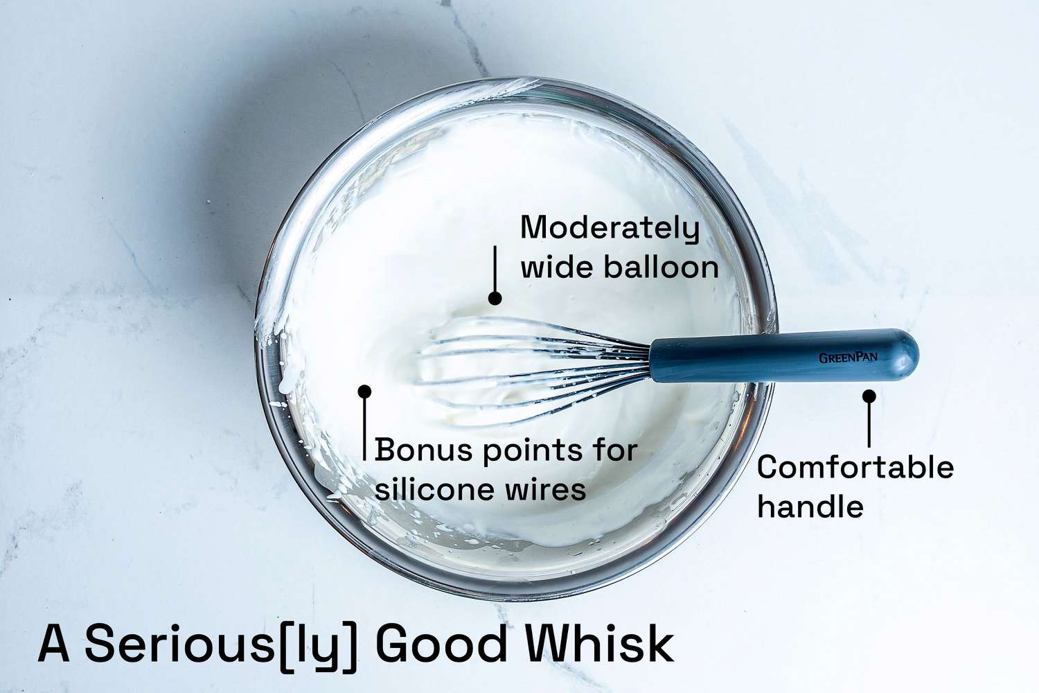 The Greenpan whisks in a metal mixing bowl of whipped cream