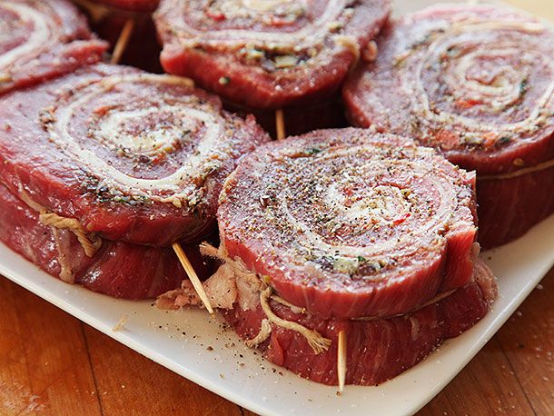 Stuffed, rolled, and cut pieces of flank steak seasoned generously with salt and pepper