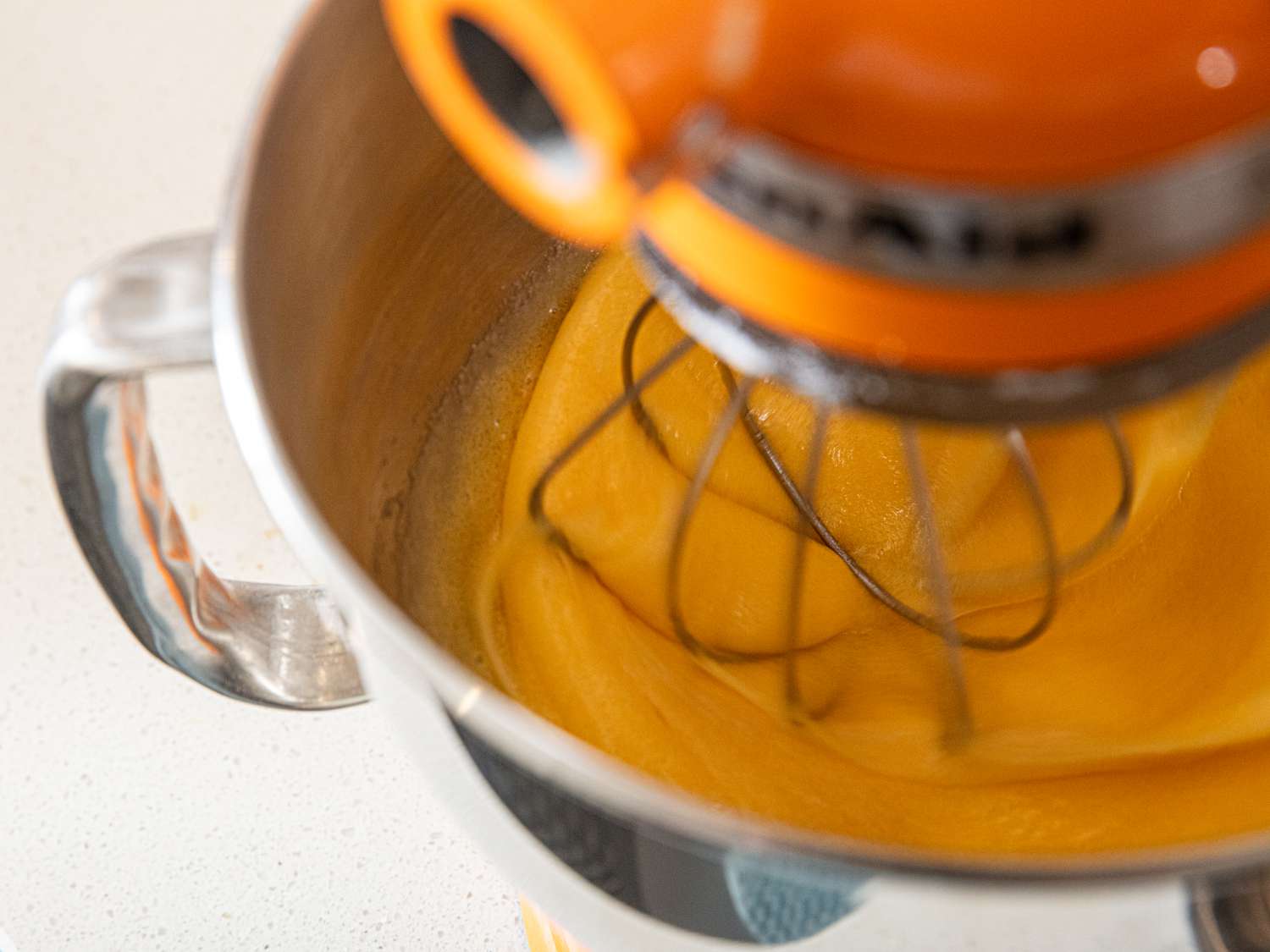 A stand mixer mixing batter, viewed from above