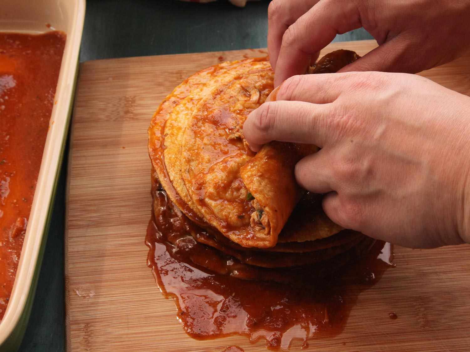 Rolling the enchiladas.