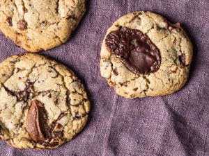 Quick and easy chocolate chip cookies on a purple linen. 