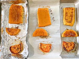 Baked vegetable slices on foillined trays arranged in sections