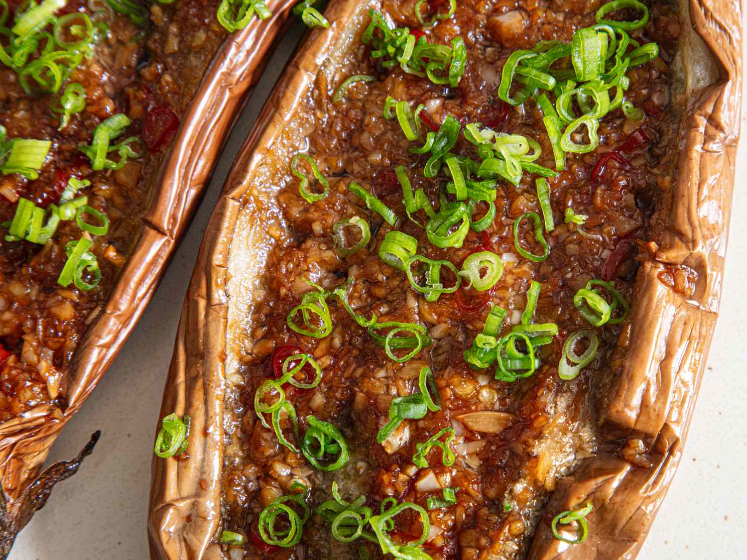 Roasted Chinesestyle eggplant halves topped with green onions
