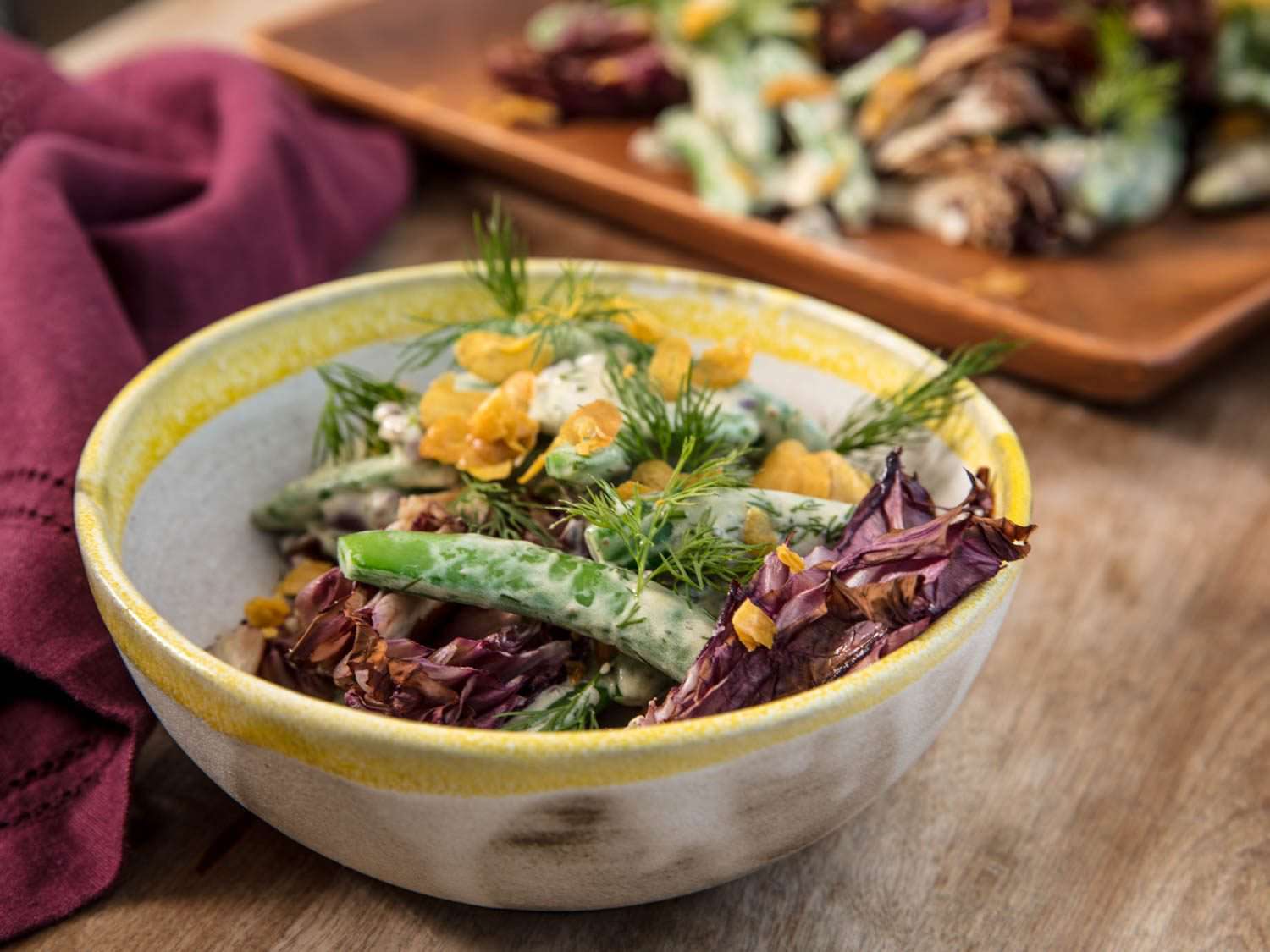 Sugar snap peas with garlic yogurt dressing and charred radicchio