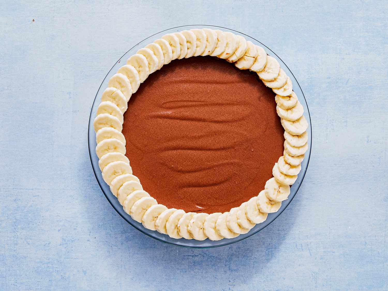 A chocolate pie garnished with a border of banana slices