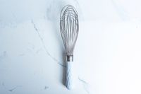 GIR Ultimate Whisk on a marbled surface