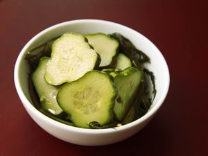 Closeup of a small bowl filled with quick dill pickle chips.