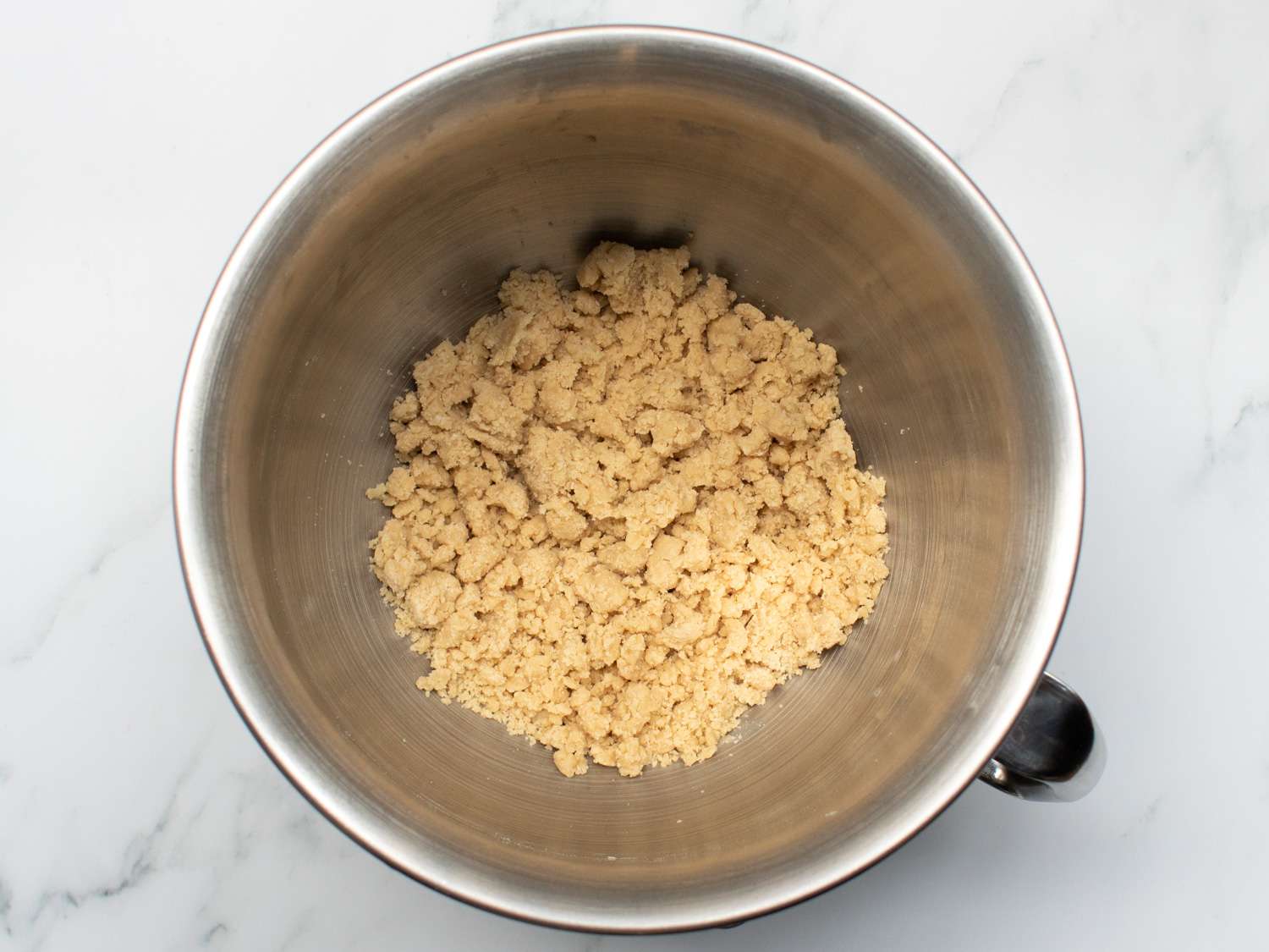 Overhead of the brown sugar mixture that had salt and flour added and mixed to form a damp and crumbly dough.