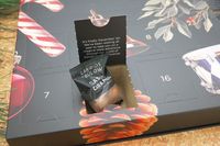A door of the Lakrids by Bülow Holiday Advent Calendar open to reveal a bag of caramel licorice