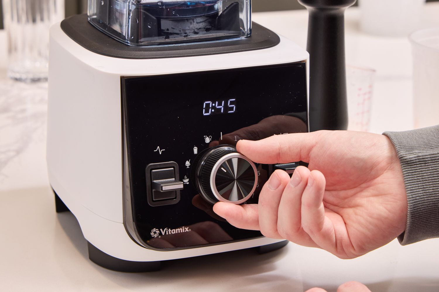 A person turns a dial on the Vitamix Ascent X2 Blender