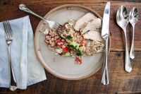 Robert Welch Westbury Flatware Set next to a plate of food