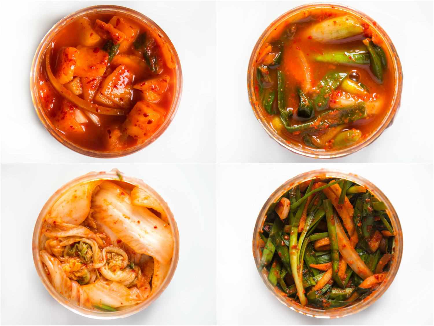 Four different types of kimchi in four bowls.