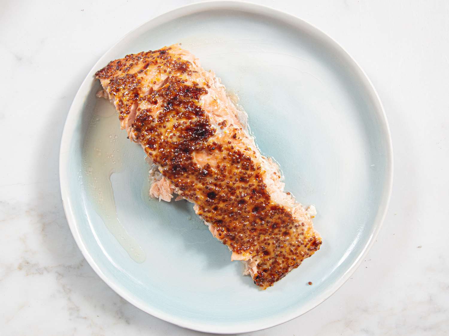 Overhead view of piece of salmon on plate