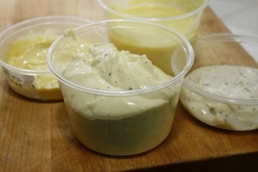 Spicy duckonnaise in a pint-sized deli container, flanked by other "meatonnaise" experiments.