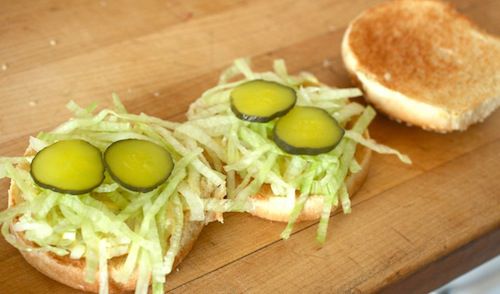 The two bottom-most buns of the better Big Mac are topped with lettuce and pickle slices.