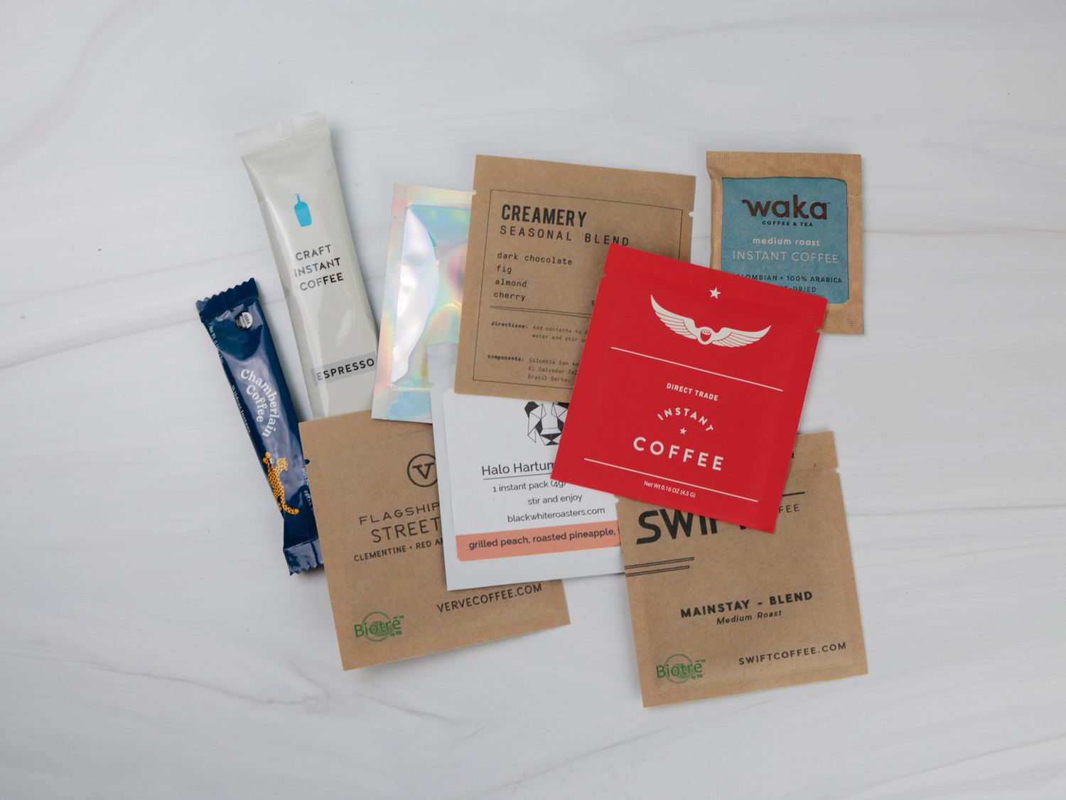 a handful of different instant coffee packets showing different sizes