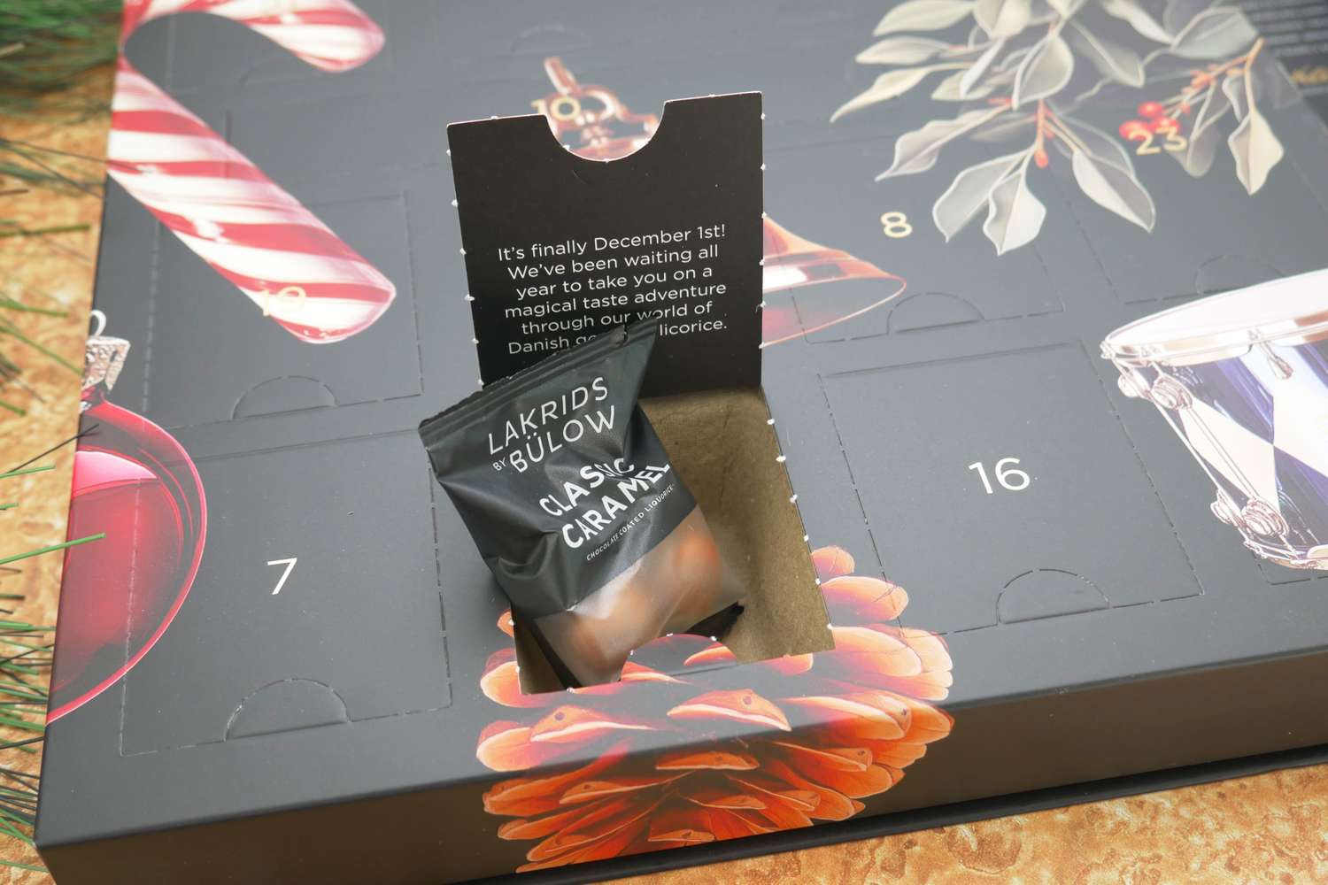 A door of the Lakrids by Bülow Holiday Advent Calendar open to reveal a bag of caramel licorice