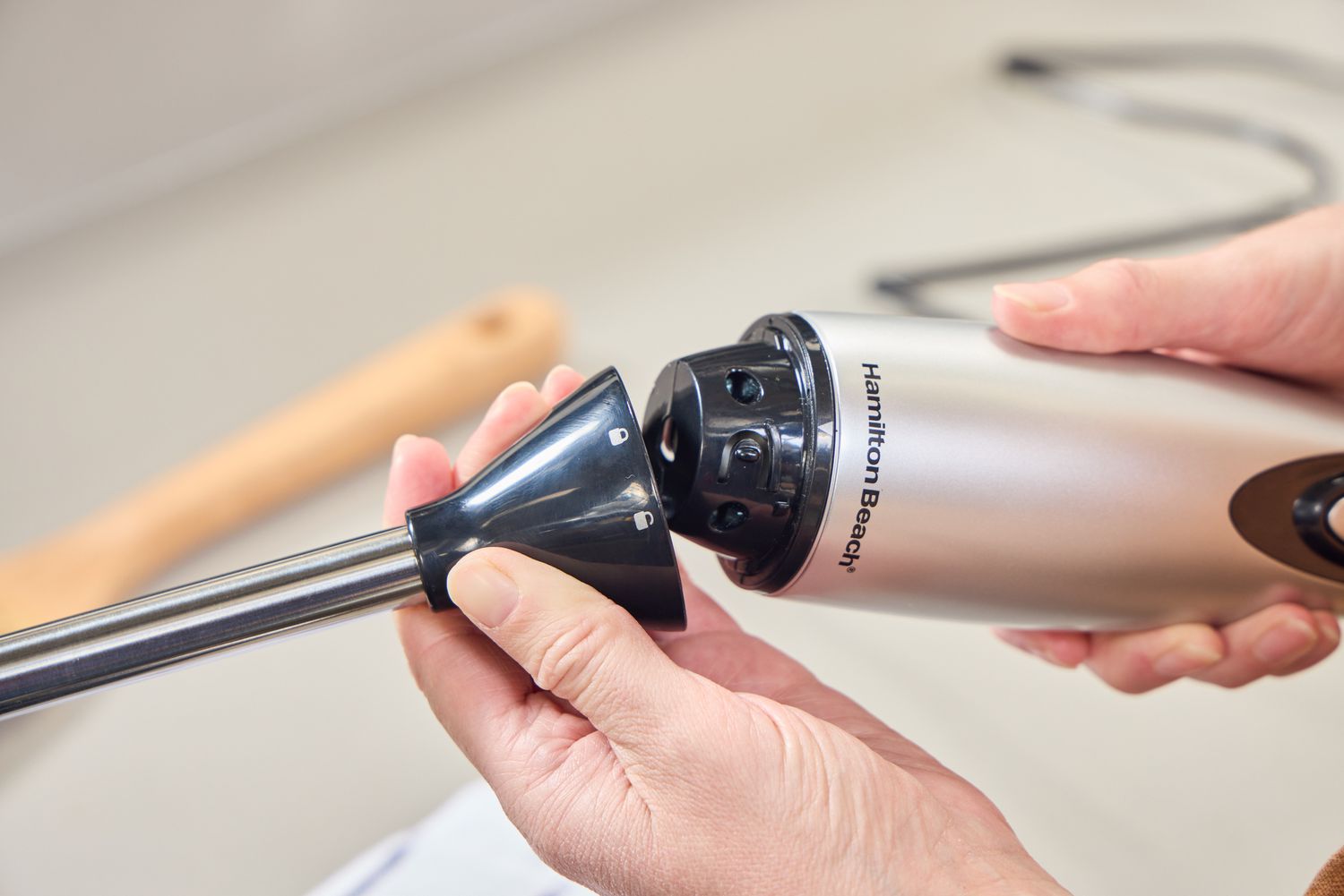 A person assembles the Hamilton Beach 2-Speed Hand Blender
