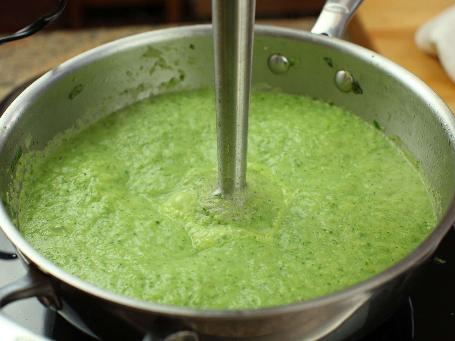 The simmered zucchini, leek, and basil is puréed with an immersion blender directly in the pot.