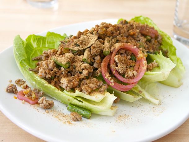A platter of duck larb on romaine lettuce leaves. 