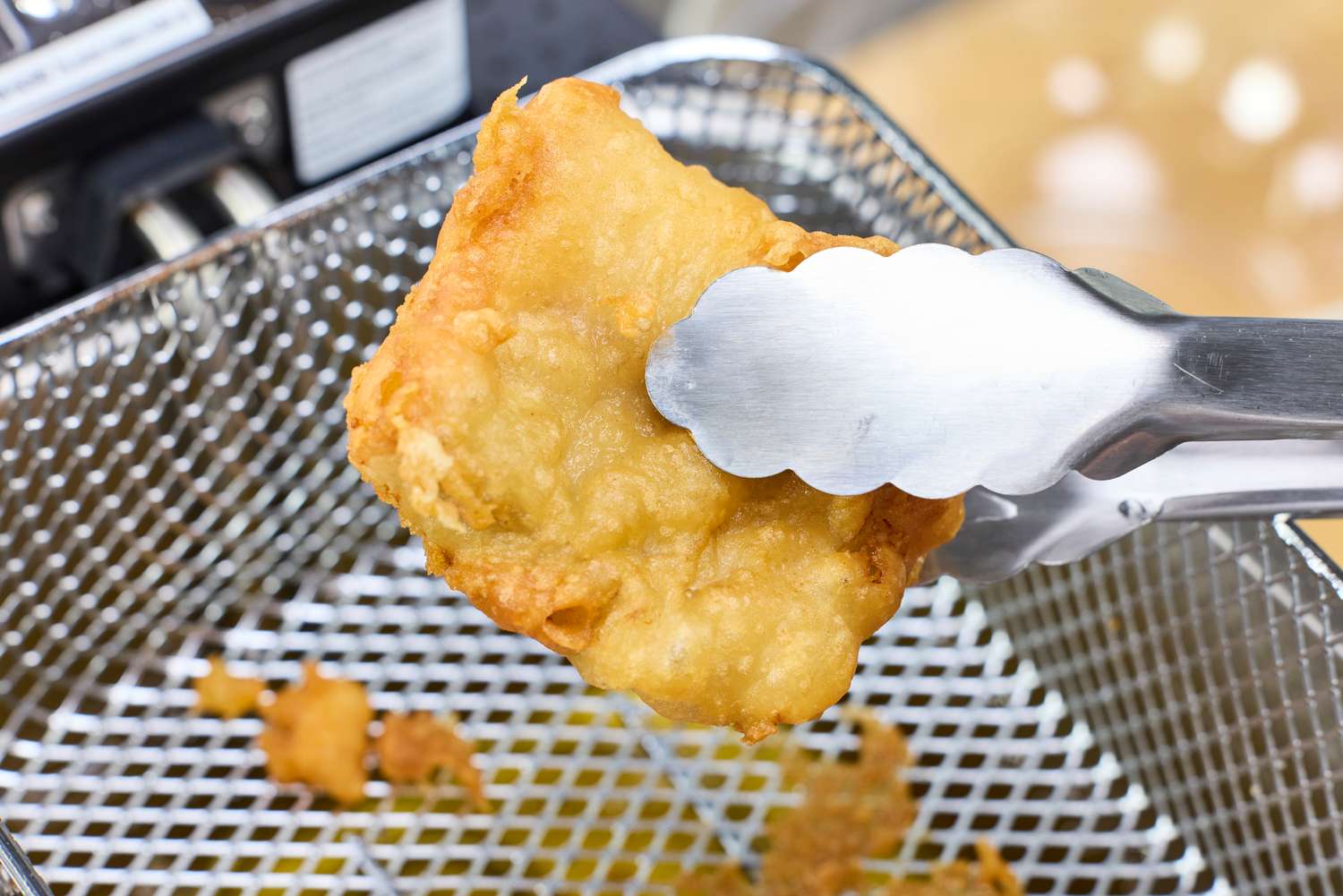 A piece of fried food cooked in the All-Clad Easy Clean Pro 3.5L Electric Deep Fryer