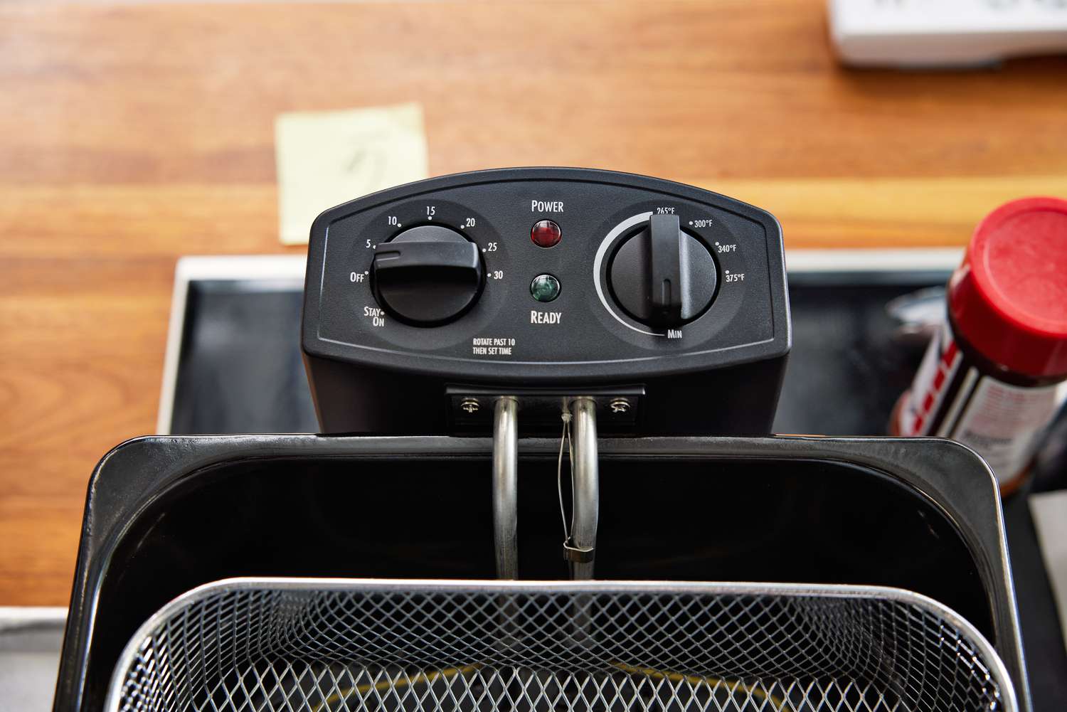 a closeup of two analog control dials on an electric deep fryer
