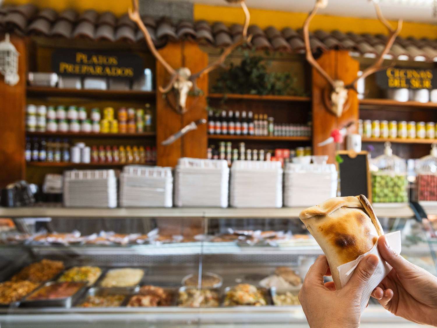 Isidora holding an empanada at Los Ciervos