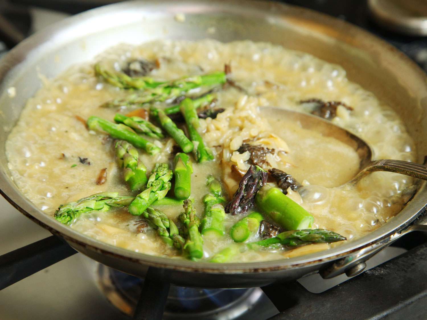 Asparagus is added to the pan.