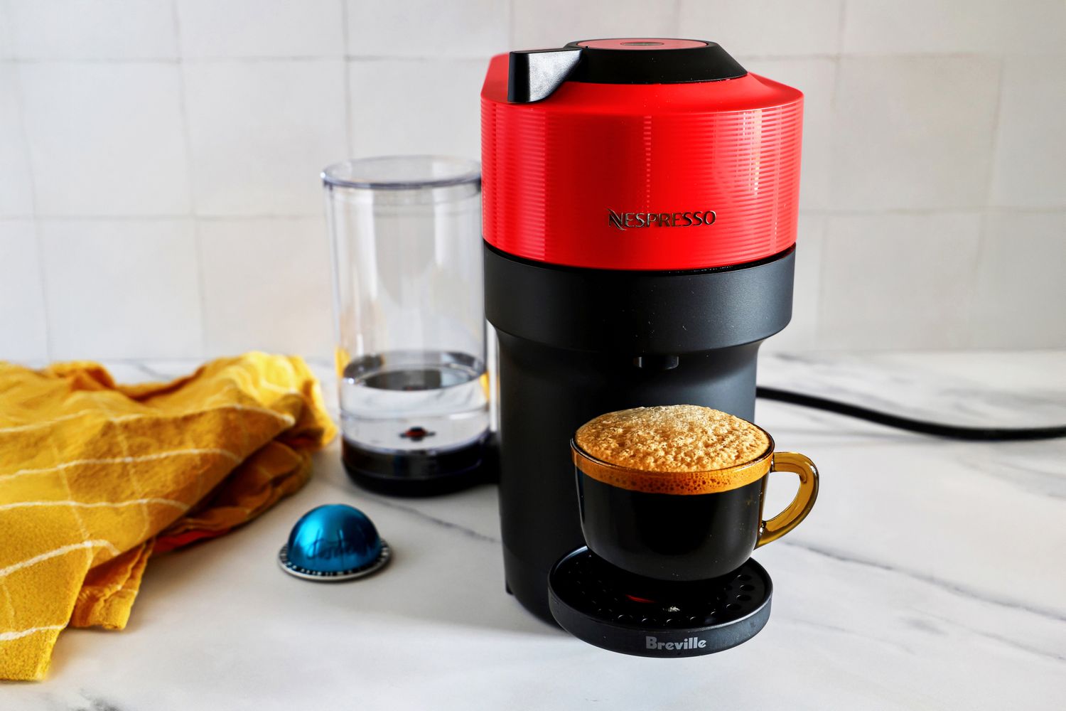 Nespresso Vertuo Pop coffee and espresso maker by Breville brewing coffee into a black cup