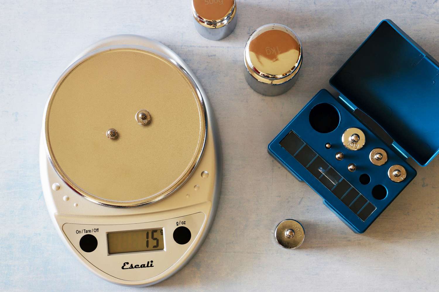 Two small calibration weights on a kitchen scale