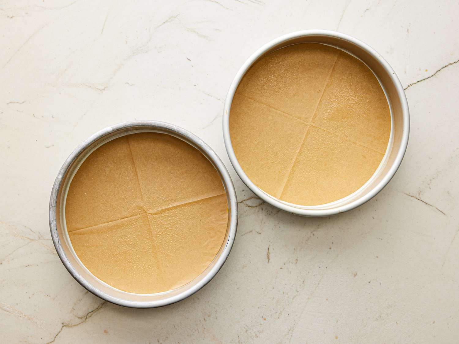 Two pans layered with parchment paper