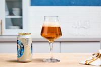 A Rastal Teku tulip glass filled with beer.