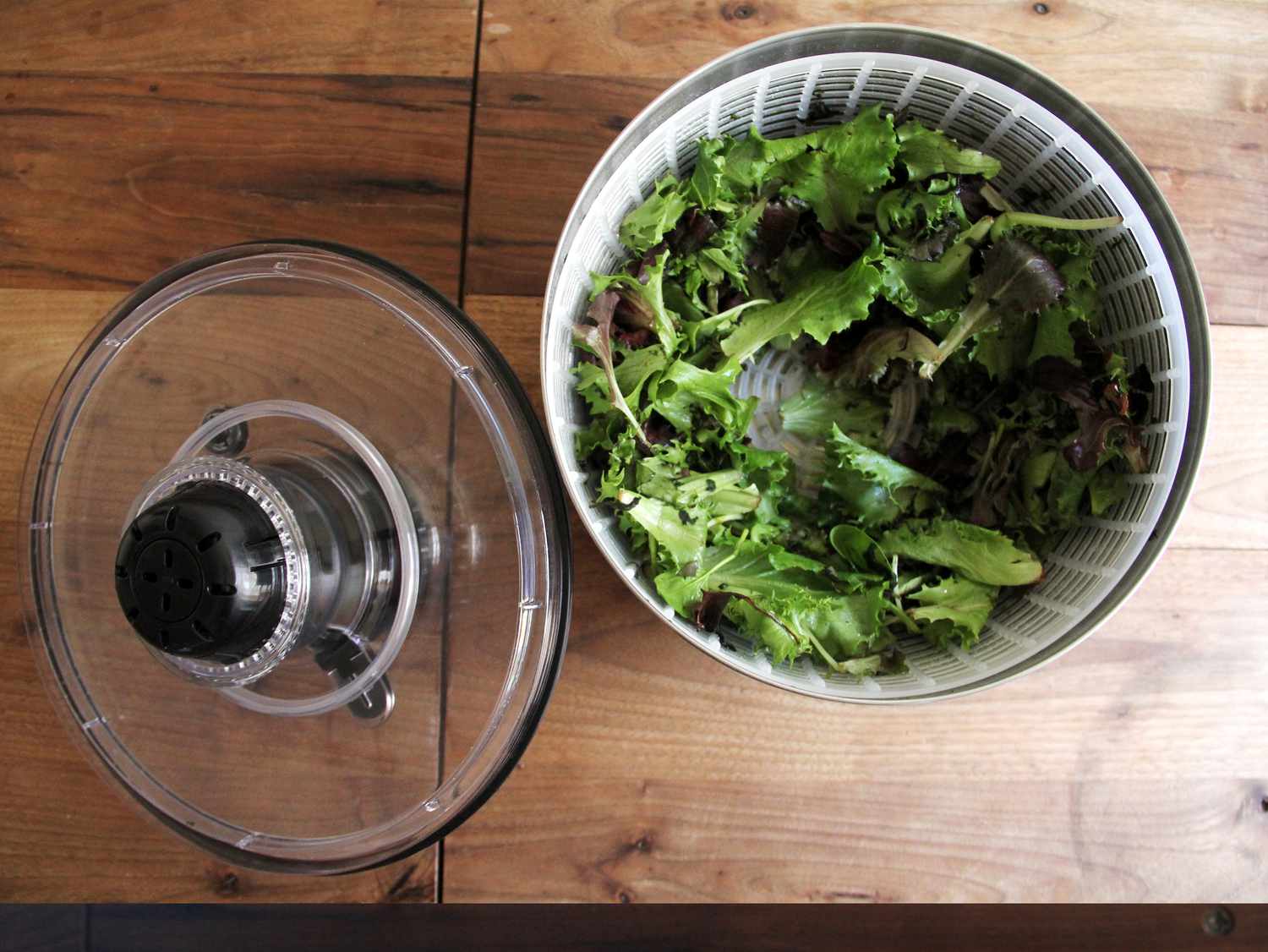 The OXO steel salad spinner with dry greens inside and its lid off