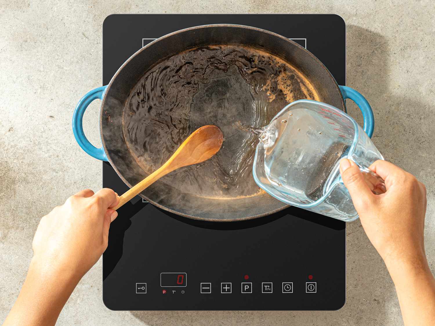 Overhead view of adding water to dutch oven