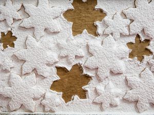 Overhead of sugar cookies covered in thick layer of powdered sugar