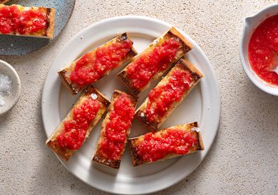 Pan Con Tomate (Spanish-Style Grilled Bread With Tomato) on a white ceramic plate.