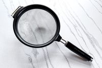 KitchenAid Classic Strainer with a black handle on a marbled surface