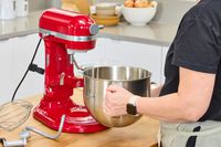 A person removes the bowl from the KitchenAid 7 Quart Bowl Lift Stand Mixer