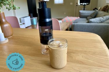 The OXO Rapid Brewer next to a cup of iced coffee on a kitchen table